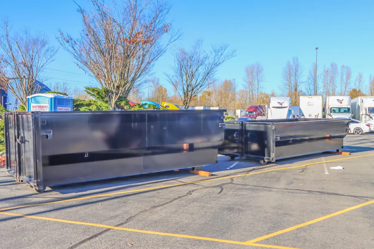 Professional dumpster rental service with roll-off container on residential driveway in Dillon
